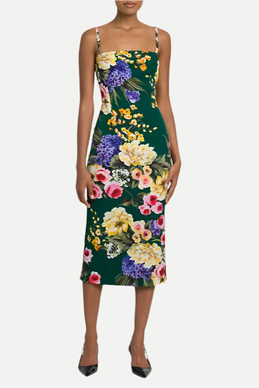 A model wearing a green floral print sheath midi dress with spaghetti straps and a straight neckline.